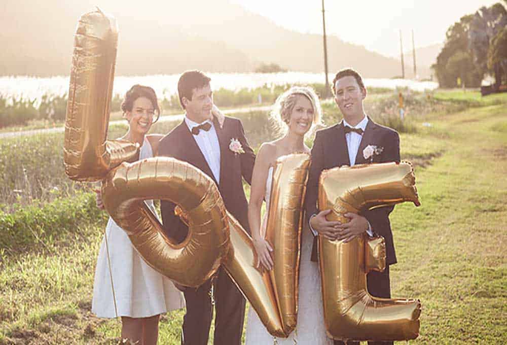 Bridal party with a LOVE balloon.