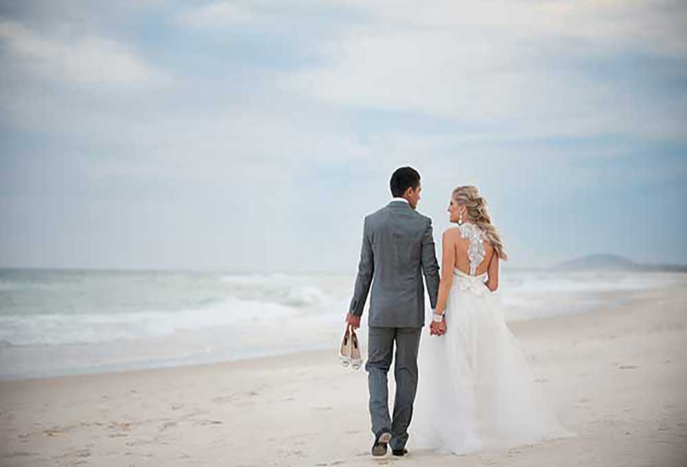 Bride and groom for their beach wedding in winter