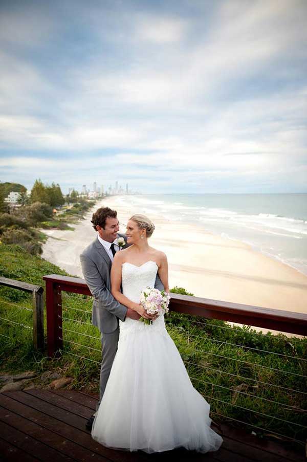 Bride and groom with the beach in the background