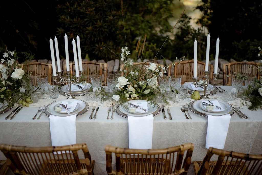 Elegant wedding reception table setup ideal for planning your Queensland wedding, featuring sophisticated tableware and lush floral arrangements