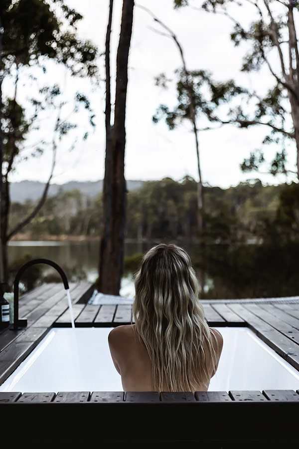 Unwind in the serene embrace of Tasmania’s Huon Valley at The Voyager, an Airbnb residence offering breathtaking views from a secluded outdoor tub